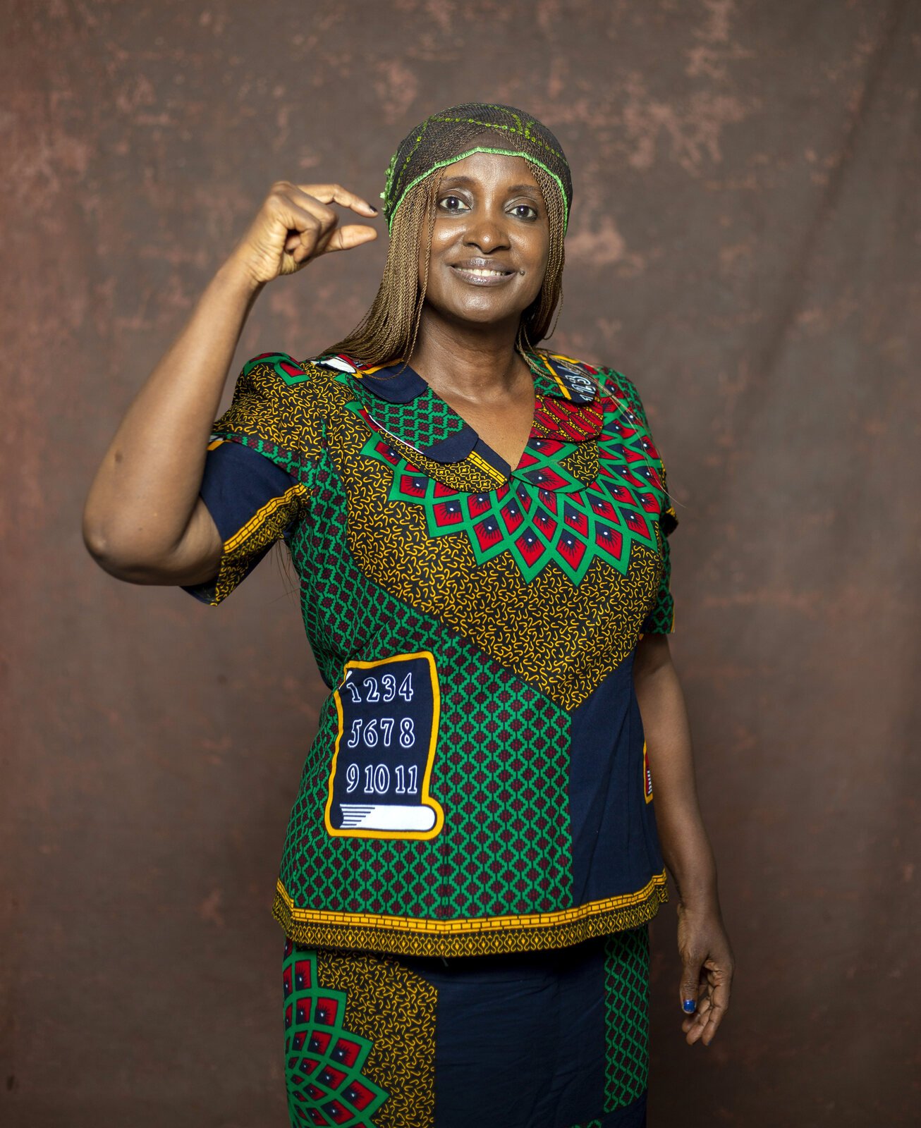 Maria Ude Nwachi raising her hand in a gesture of strength